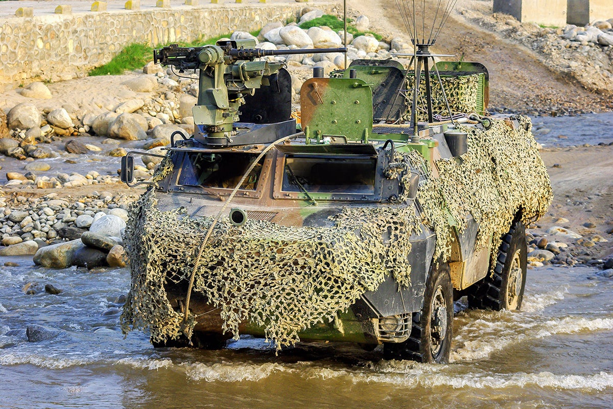 Char blindé et camouflé dans une rivière